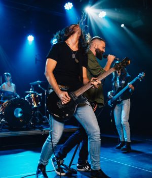 rock-band-performing-energetically-on-stage-under-blue-lights.jpg